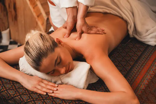 Therapist performing deep tissue massage technique in Earls Court, London